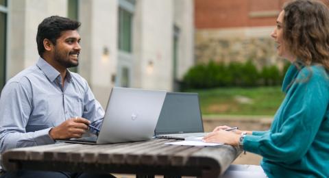 Image of students on laptop outside on UNH Durham Campus 
