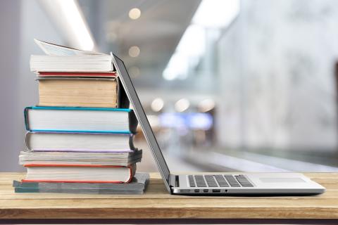 Laptop on Desk with Books